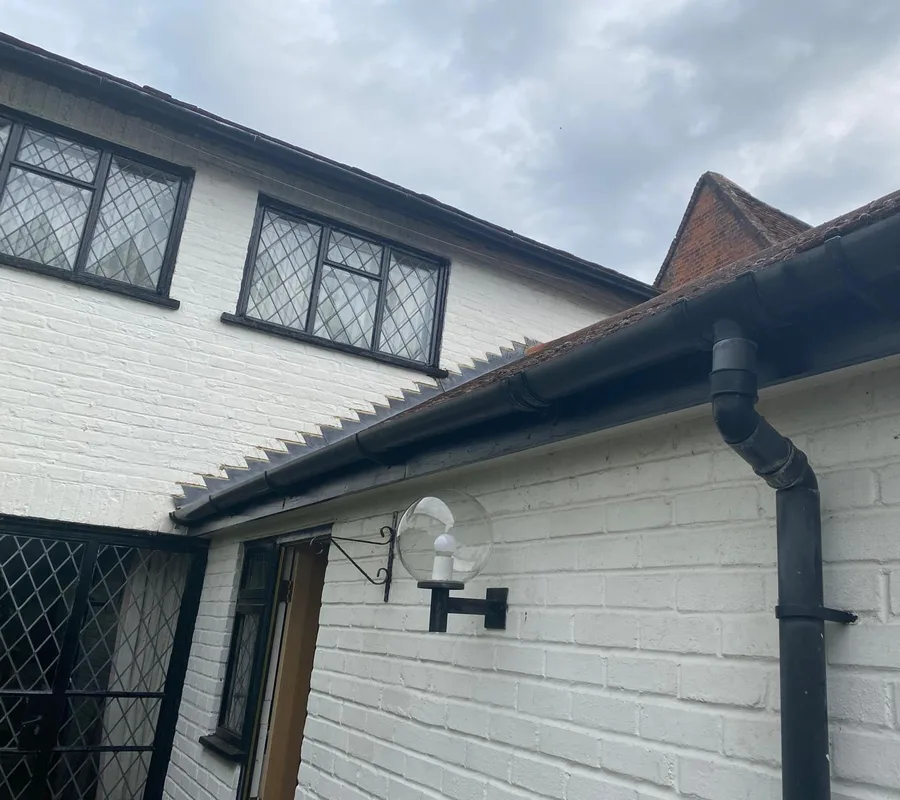 New black guttering and fascias on a white house