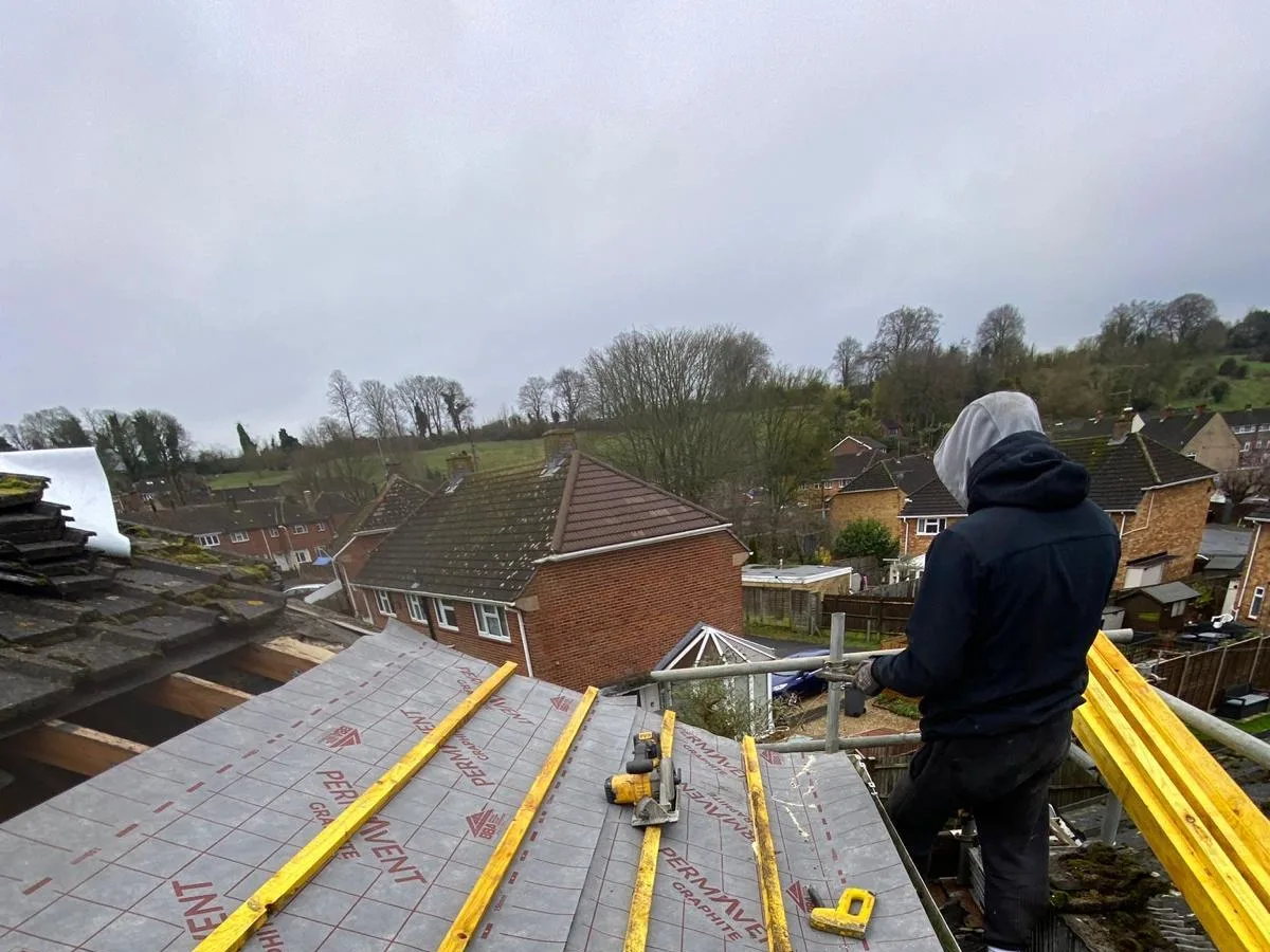 A roofer on a re-roof in Hampshire
